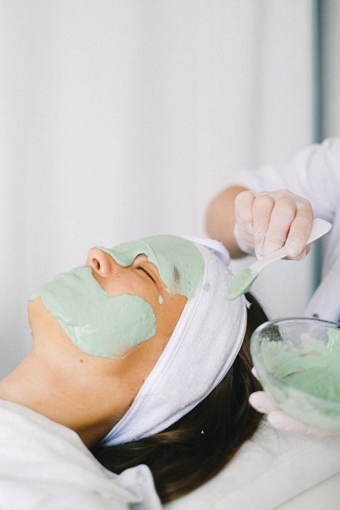 facial treatment and skincare applying a facial mask on client's face